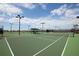 Beautifully lit outdoor tennis court at 20398 Lagente Cir, Venice, FL 34293