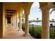Covered walkway with arched pillars, overlooking the pool at 20398 Lagente Cir, Venice, FL 34293
