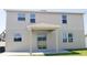 Back exterior with windows and covered patio with sliding glass doors to the interior at 215 63Rd E Dr, Bradenton, FL 34203