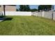 Large backyard with green grass and fenced perimeter at 215 63Rd E Dr, Bradenton, FL 34203