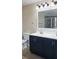 Bathroom vanity featuring dual sinks, dark cabinets, and sleek modern fixtures at 215 63Rd E Dr, Bradenton, FL 34203