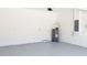 Spacious garage featuring painted floor, white walls, and water heater at 215 63Rd E Dr, Bradenton, FL 34203