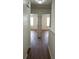 Hallway with wood-look flooring leading to multiple rooms at 215 63Rd E Dr, Bradenton, FL 34203