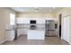 Modern kitchen featuring stainless steel appliances, an island, and granite countertops at 215 63Rd E Dr, Bradenton, FL 34203