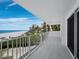 Spacious balcony overlooking a pristine beach with clear, blue ocean waters at 2301 Gulf Of Mexico Dr # 36N, Longboat Key, FL 34228