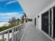 Expansive balcony overlooking the beach and ocean, with modern railings and sliding glass doors at 2301 Gulf Of Mexico Dr # 36N, Longboat Key, FL 34228