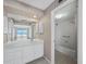 Bathroom with a white vanity, a large mirror, and a view of the beach at 2301 Gulf Of Mexico Dr # 36N, Longboat Key, FL 34228