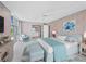 Bright bedroom with a view and coastal decor with pink walls and blue accents at 2301 Gulf Of Mexico Dr # 36N, Longboat Key, FL 34228