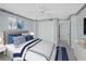 Cozy bedroom featuring calming blue accents, plush bedding, ceiling fan, and ample closet space at 2301 Gulf Of Mexico Dr # 36N, Longboat Key, FL 34228
