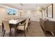 Elegant dining room with stylish table, modern lighting, and decorative stone wall at 2301 Gulf Of Mexico Dr # 36N, Longboat Key, FL 34228