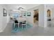 Cozy dining room with a white table, blue accents, mirrored wall, and a view of the Gulf through sliding doors at 2301 Gulf Of Mexico Dr # 36N, Longboat Key, FL 34228