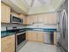 Well-lit kitchen features stainless steel appliances, including a microwave, oven, dishwasher, and refrigerator at 2301 Gulf Of Mexico Dr # 36N, Longboat Key, FL 34228