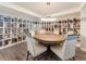 Charming library featuring bookshelves and a cozy round table, ideal for reading and relaxation at 2301 Gulf Of Mexico Dr # 36N, Longboat Key, FL 34228