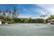 Outdoor tennis court surrounded by lush landscaping, perfect for recreational play at 2301 Gulf Of Mexico Dr # 36N, Longboat Key, FL 34228