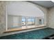 Beach view through an arched window over a teal countertop with cabinets below at 2301 Gulf Of Mexico Dr # 36N, Longboat Key, FL 34228