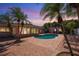Inviting backyard with swimming pool, brick patio, lush landscaping and lounge chairs at 2609 Webber St, Sarasota, FL 34239