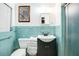 This bathroom features a blue tiled wall, toilet, vanity, and shower with vintage aesthetic at 2609 Webber St, Sarasota, FL 34239