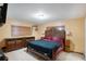 Spacious bedroom with wooden furniture and yellow walls with carpeted flooring at 2609 Webber St, Sarasota, FL 34239