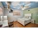 Whimsical bedroom with cloud painted ceiling, hanging decor, and wood laminate flooring at 2609 Webber St, Sarasota, FL 34239