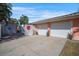 Two car garage and additional one car garage with a spacious driveway and landscaping at 2609 Webber St, Sarasota, FL 34239