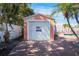 Garage exterior with a brick paver driveway and lush tropical landscaping at 2609 Webber St, Sarasota, FL 34239
