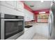 White kitchen with stainless steel oven and microwave appliances, bright with natural light at 2609 Webber St, Sarasota, FL 34239