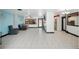 Open living area with tile floors, a view to the kitchen and access to the backyard at 2609 Webber St, Sarasota, FL 34239
