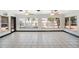 Large living room with tile floors and windows overlooking the pool and patio area at 2609 Webber St, Sarasota, FL 34239