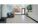 Comfortable living area with tile floors, large window and wall-mounted television at 2609 Webber St, Sarasota, FL 34239