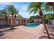 Inviting backyard pool area with palm trees, lush landscaping, and brick paver patio for outdoor entertaining at 2609 Webber St, Sarasota, FL 34239