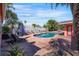 Beautiful pool area surrounded by lush landscaping and a brick paver patio with lounge chairs at 2609 Webber St, Sarasota, FL 34239