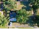 Aerial view of a property with mature trees, grassy yard, and a house with a covered carport at 2906 Arlington St, Sarasota, FL 34239
