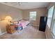 Cozy bedroom features a vintage bedframe and a large window for natural light at 2906 Arlington St, Sarasota, FL 34239