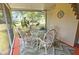 Screened in porch area featuring a dining table and compass decor at 2906 Arlington St, Sarasota, FL 34239