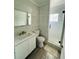 Bathroom featuring sleek vanity, toilet, and a glass-enclosed walk-in shower with stylish tile at 3101 Bee Ridge Rd # 221, Sarasota, FL 34239