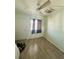 Bedroom with light wood-look flooring, ceiling fan, and window with curtains at 3101 Bee Ridge Rd # 221, Sarasota, FL 34239