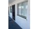 Condo exterior shows the front door and window with a white stucco finish at 3101 Bee Ridge Rd # 221, Sarasota, FL 34239