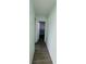 Hallway showing plank tile flooring and entry into another room at 3101 Bee Ridge Rd # 221, Sarasota, FL 34239