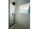 Walk-in shower features white marble tiling, a window and modern black shower head and handle at 3101 Bee Ridge Rd # 221, Sarasota, FL 34239