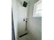 Walk-in shower features white marble tiling, a window and modern black shower head and handle at 3101 Bee Ridge Rd # 221, Sarasota, FL 34239