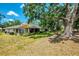 Landscaped backyard featuring mature trees and an expansive lawn at 314 Pembroke Ln # 189, Venice, FL 34293