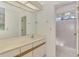 Well-lit bathroom featuring a vanity with a large mirror and a walk-in shower with a glass door at 314 Pembroke Ln # 189, Venice, FL 34293