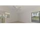 Well-lit bedroom with large windows, ceiling fan, and mirrored closet that amplify the spaciousness of the room at 314 Pembroke Ln # 189, Venice, FL 34293