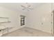 Bedroom featuring a ceiling fan, window and door with an adjacent built-in shelving unit at 314 Pembroke Ln # 189, Venice, FL 34293