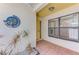 Inviting entryway with tiled floor, stylish door, and decorative wall art at 314 Pembroke Ln # 189, Venice, FL 34293