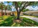 Inviting home exterior with lush lawn and mature trees, showcasing a serene setting at 314 Pembroke Ln # 189, Venice, FL 34293