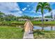 Scenic neighborhood view with a charming wooden bridge over a small lake and lush landscaping at 314 Pembroke Ln # 189, Venice, FL 34293