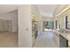 Bright kitchen with white cabinets, tile flooring, and a sliding door to the outdoors at 314 Pembroke Ln # 189, Venice, FL 34293