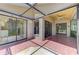 A tiled lanai leads to the interior through sliding glass doors at 314 Pembroke Ln # 189, Venice, FL 34293