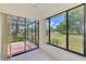 Bright living area with screened lanai access and expansive windows that offer natural light and views of the landscaped yard at 314 Pembroke Ln # 189, Venice, FL 34293